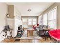 Bright living room with hardwood floors, a decorative fireplace, and a cozy seating area with natural light at 637 Berkley Rd, Indianapolis, IN 46208