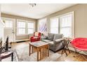 Sunlit living room featuring hardwood floors, ample seating, and a decorative fireplace, creating a welcoming atmosphere at 637 Berkley Rd, Indianapolis, IN 46208
