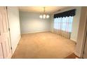 Bright, carpeted room with neutral walls, crown molding, and plenty of natural light at 7121 Fields Way, Indianapolis, IN 46239