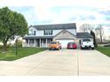 Charming two-story home featuring a brick-accented facade, attached garage, and well-manicured lawn at 7121 Fields Way, Indianapolis, IN 46239