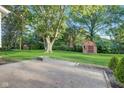Great backyard with patio, fire pit, and shed in a well-landscaped yard, ideal for outdoor living at 7206 Halden Pl, Indianapolis, IN 46214