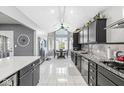 Well-lit kitchen with black cabinets, stainless steel appliances, granite countertops and a dining area at 7280 E Patricia Dr, Camby, IN 46113