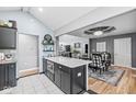 Open kitchen with island featuring seating, leading to an adjacent dining area at 7280 E Patricia Dr, Camby, IN 46113