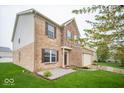 A two-story brick home with a two-car garage, stone accents, and landscaped front yard at 844 Fireside Dr, Greenwood, IN 46143