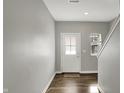Bright foyer with wood floors, neutral paint, and a white front door and staircase at 8583 Strabet Dr, Pendleton, IN 46064