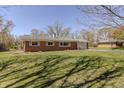 Charming brick home features a large, well-manicured lawn at 10586 W School Pkwy, Carmel, IN 46280
