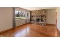 Inviting living room with hardwood floors and a striking stone fireplace at 10586 W School Pkwy, Carmel, IN 46280
