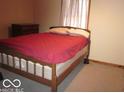 Cozy bedroom with a plush bed and soft lighting at 1080 W Wildflower Ct, Mooresville, IN 46158