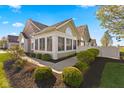 A charming exterior view showcases the home's architectural details, including stone accents and manicured landscaping at 1098 Extraordinary Trl, Greenfield, IN 46140