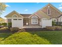 Charming home featuring a combination of stone and siding, complemented by a well-manicured lawn and stylish fence at 1098 Extraordinary Trl, Greenfield, IN 46140