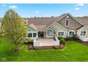 Aerial view of a home with stone and siding, complemented by a manicured lawn and stylish fence at 1098 Extraordinary Trl, Greenfield, IN 46140