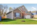Beautiful exterior view of single Gathering home with landscaped yard and brick accents at 122 Winding Brook Way, Pendleton, IN 46064