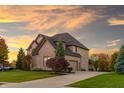 Lovely brick home with a spacious driveway, two-car garage and a basketball court at 12372 Ostara Ct, Fishers, IN 46037