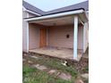 View of the covered front porch with concrete flooring and exterior siding at 1309 W Memorial Dr, Muncie, IN 47302