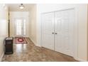 Inviting entryway with tiled flooring, coat closet, and decorative front door at 14014 Fieldcrest Dr, McCordsville, IN 46055