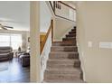 Elegant staircase with carpeted steps and a white railing, leading to the upper level at 1611 Connemara Rd, Indianapolis, IN 46217