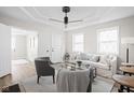 Bright living room featuring modern decor, wood flooring, and plenty of natural light from large windows at 1613 E Ohio St, Indianapolis, IN 46201