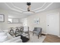 Bright living room with modern decor, recessed lighting, ceiling fan, and an open layout to the kitchen at 1613 E Ohio St, Indianapolis, IN 46201