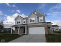 Beautiful two-story home featuring a two-car garage, covered front porch, and eye-catching curb appeal at 17062 Cowbell Dr, Noblesville, IN 46060