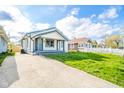 View of the charming exterior with white siding, and a driveway at 2034 Mansfield St, Indianapolis, IN 46202