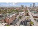 Wide aerial view of the apartment building and surrounding neighborhood with a downtown skyline at 230 E 9Th St # 401, Indianapolis, IN 46204