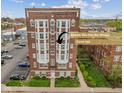 Brick apartment building featuring bright windows and mature landscaping with a corner unit highlighted at 230 E 9Th St # 401, Indianapolis, IN 46204