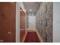 Hallway features wood doors and wallpaper with a striking pattern at 233 E Saint Joseph St # 2G, Indianapolis, IN 46202