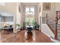 Spacious dining area with hardwood floors and high ceilings adjacent to a living area and staircase at 2705 April Springs View, Carmel, IN 46074