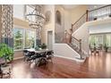 Stunning dining area featuring a dramatic chandelier, grand staircase and ample natural light at 2705 April Springs View, Carmel, IN 46074
