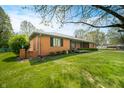 Beautiful brick home with a lush green lawn and mature trees at 273 N Serenity Way, Greenwood, IN 46142