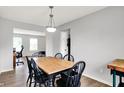 Cozy dining room featuring a wooden table with black chairs and modern pendant lighting at 286 Fairfax Ln, Greenwood, IN 46142
