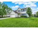 Well-maintained home with a lush green lawn, mature trees, and a beautifully landscaped yard at 286 Fairfax Ln, Greenwood, IN 46142