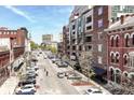 Street view of city neighborhood with apartment buildings and street parking on a bright sunny day at 333 Massachusetts Ave # 303, Indianapolis, IN 46204