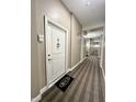 Hallway with carpet, white door, and unit number displayed at 355 E Ohio St # Ste 105, Indianapolis, IN 46204