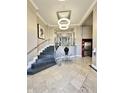Elegant lobby with marble floors, modern light fixture, staircase, elevator and decorative table arrangement at 355 E Ohio St # Ste 105, Indianapolis, IN 46204