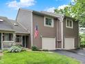 Charming two-story home with an attached two-car garage, American flag, and well-maintained landscaping at 3646 Beach Blvd, Cicero, IN 46034