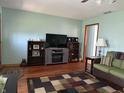 Comfortable living room with entertainment center, dark wood shelves, and an area rug at 3883 N 150 W, Columbus, IN 47201