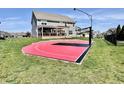 Backyard view of home with patio, sports court, and a manicured lawn at 4205 Hunt Club Pkwy, Bargersville, IN 46106