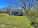 Exterior of house with lawn, trees and blue sky in background on a sunny day at 4520 Clinton St, Indianapolis, IN 46226