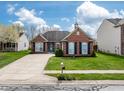 Charming brick home featuring a well-kept lawn, concrete driveway, and tidy landscaping at 4729 Beach Club Dr, Noblesville, IN 46062