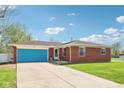 Beautiful brick home featuring a blue garage door and long driveway at 4905 Candy Spots Dr, Indianapolis, IN 46237