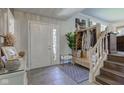 Welcoming home foyer with decorative console table, charming wood accent bench, and easy access to stairs at 4977 Beechwood Rd, Avon, IN 46123