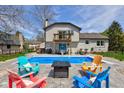 Inviting backyard oasis with a refreshing pool, lounge chairs, and a cozy fire pit at 4977 Beechwood Rd, Avon, IN 46123