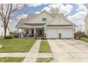 Charming two-story home with a well-maintained lawn and a two-car garage at 5007 Avian Ln, Indianapolis, IN 46235