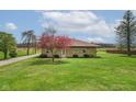 Cozy home with stone exterior, surrounded by lush green lawn and mature trees at 5551 W 200 N, Greenfield, IN 46140