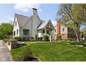 Charming white brick home with a gable roof, landscaped yard, and inviting covered front porch at 5946 N New Jersey St, Indianapolis, IN 46220