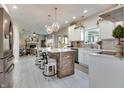 Bright, spacious kitchen with white cabinets, a large island, and modern appliances at 6054 Easy Ln, Indianapolis, IN 46259