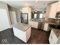 Bright kitchen with stainless steel appliances, granite countertops, and center island at 6157 Winthrop Ave, Indianapolis, IN 46220