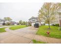 Two-story home featuring neutral siding, brick accents, attached two-car garage and well-maintained lawn at 6376 Matcumbe Way, Plainfield, IN 46168