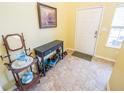 Inviting foyer area with tiled floors, an entryway table, a large mirror and natural light at 6376 Matcumbe Way, Plainfield, IN 46168